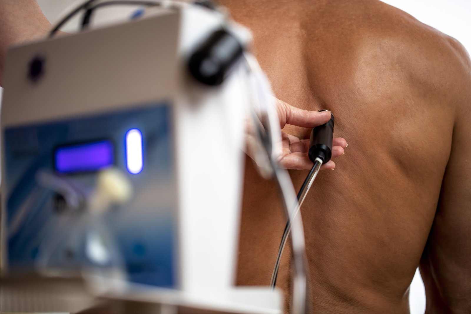 A doctor giving a gas injection of natural carbon dioxide alongside the spine